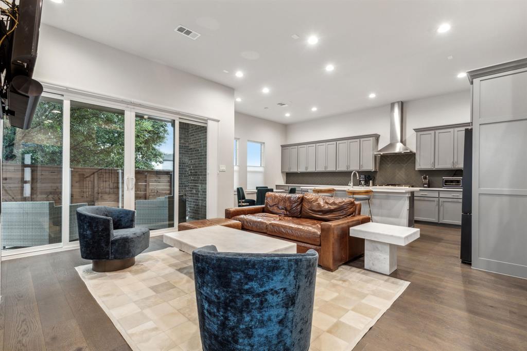 4109 Maison Ridge Dallas, TX 75219 - Photo 1 of 1 a kitchen with a refrigerator a sink dishwasher with a dining table and chairs