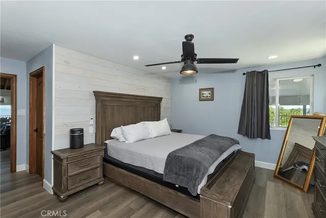a bedroom with a bed and a ceiling fan
