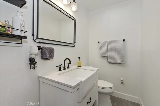 a living room with furniture pool table and a wooden floor