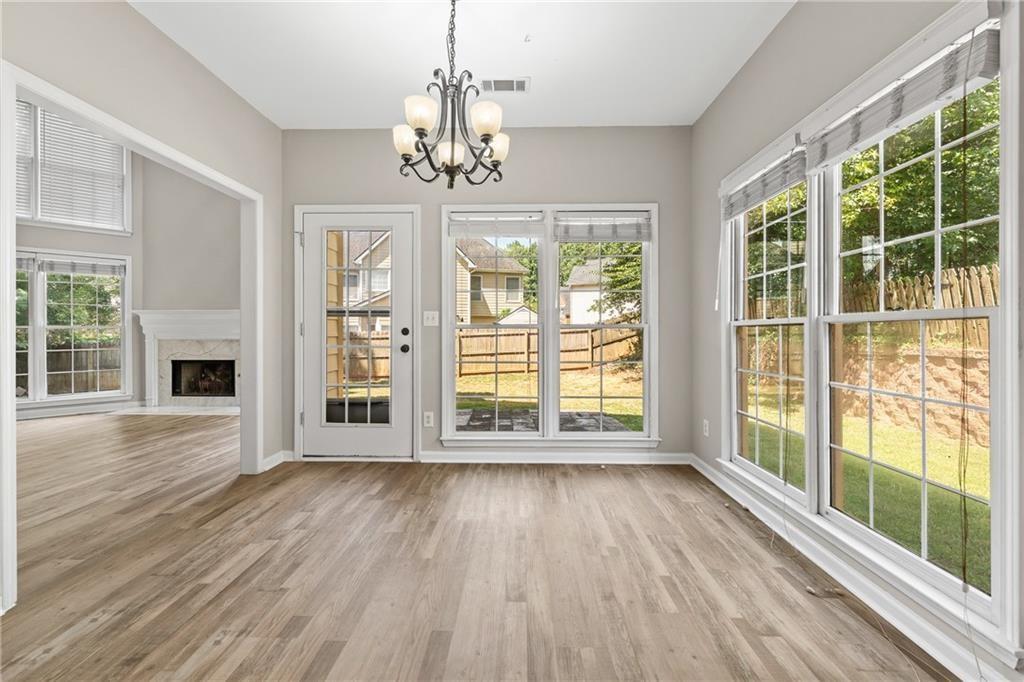 2878 Calhoun Square Suwanee, GA 30024 - Photo 16 of 42 a view of an empty room with wooden floor and a window