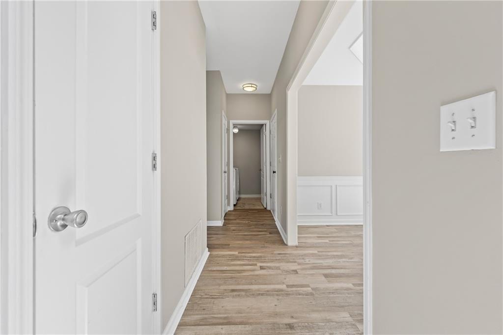 2878 Calhoun Square Suwanee, GA 30024 - Photo 19 of 42 a view of a hallway with wooden floor