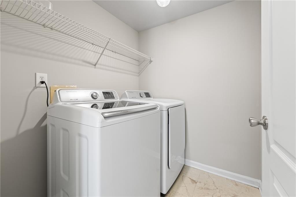 2878 Calhoun Square Suwanee, GA 30024 - Photo 20 of 42 a utility room with dryer and washer