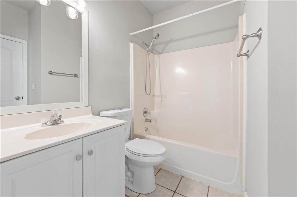 2878 Calhoun Square Suwanee, GA 30024 - Photo 21 of 42 a bathroom with a sink a toilet and shower