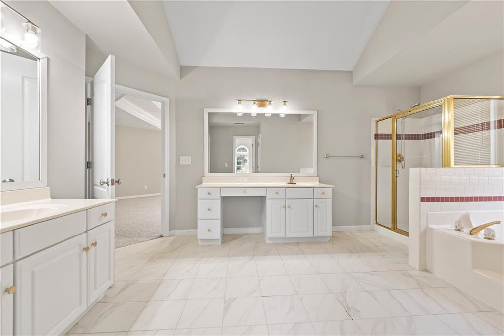 2878 Calhoun Square Suwanee, GA 30024 - Photo 26 of 42 a bathroom with a sink vanity toilet and a tub