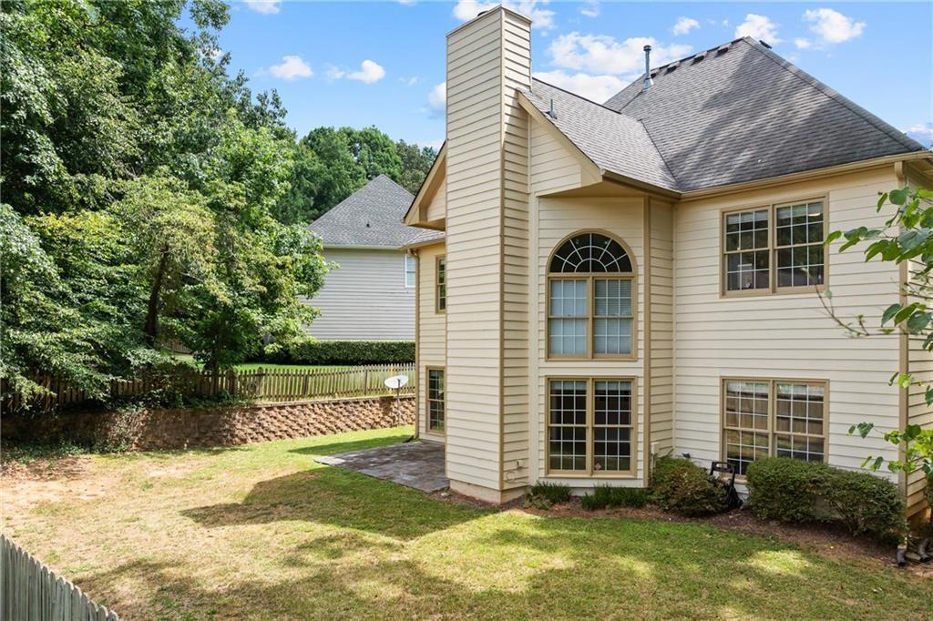 2878 Calhoun Square Suwanee, GA 30024 - Photo 38 of 42 a front view of a house with a yard