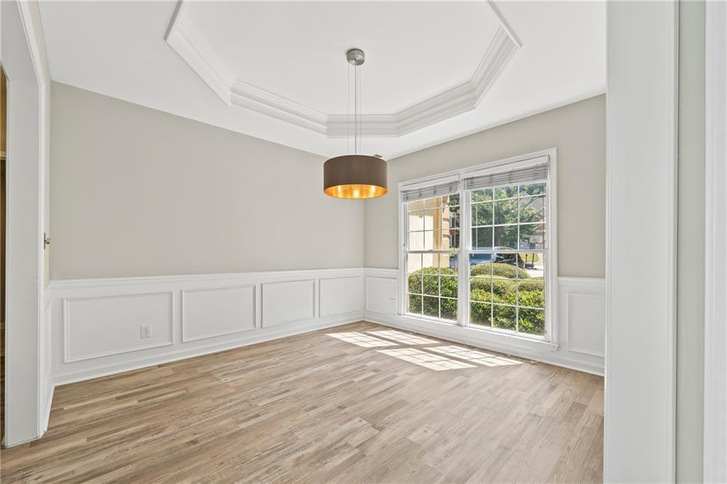 2878 Calhoun Square Suwanee, GA 30024 - Photo 6 of 42 an empty room with wooden floor and windows