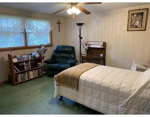 557 Southbridge Road Warren, MA 01585 - Photo 12 of 30 a bedroom with a bed and a chandelier