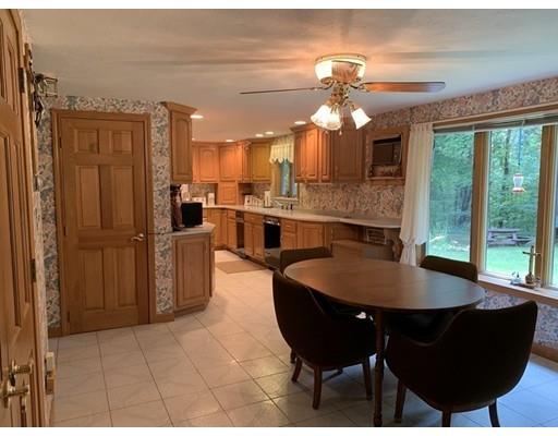 557 Southbridge Road Warren, MA 01585 - Photo 7 of 30 a large kitchen with dining table and stainless steel appliances