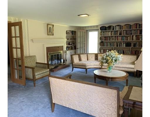 557 Southbridge Road Warren, MA 01585 - Photo 10 of 30 a living room with furniture a fireplace and a large mirror