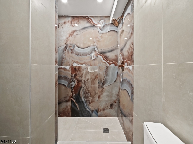 100 Chestnut Street, Unit 3 West Orange, NJ 07052 - Photo 8 of 18 a bathroom with a toilet and shower