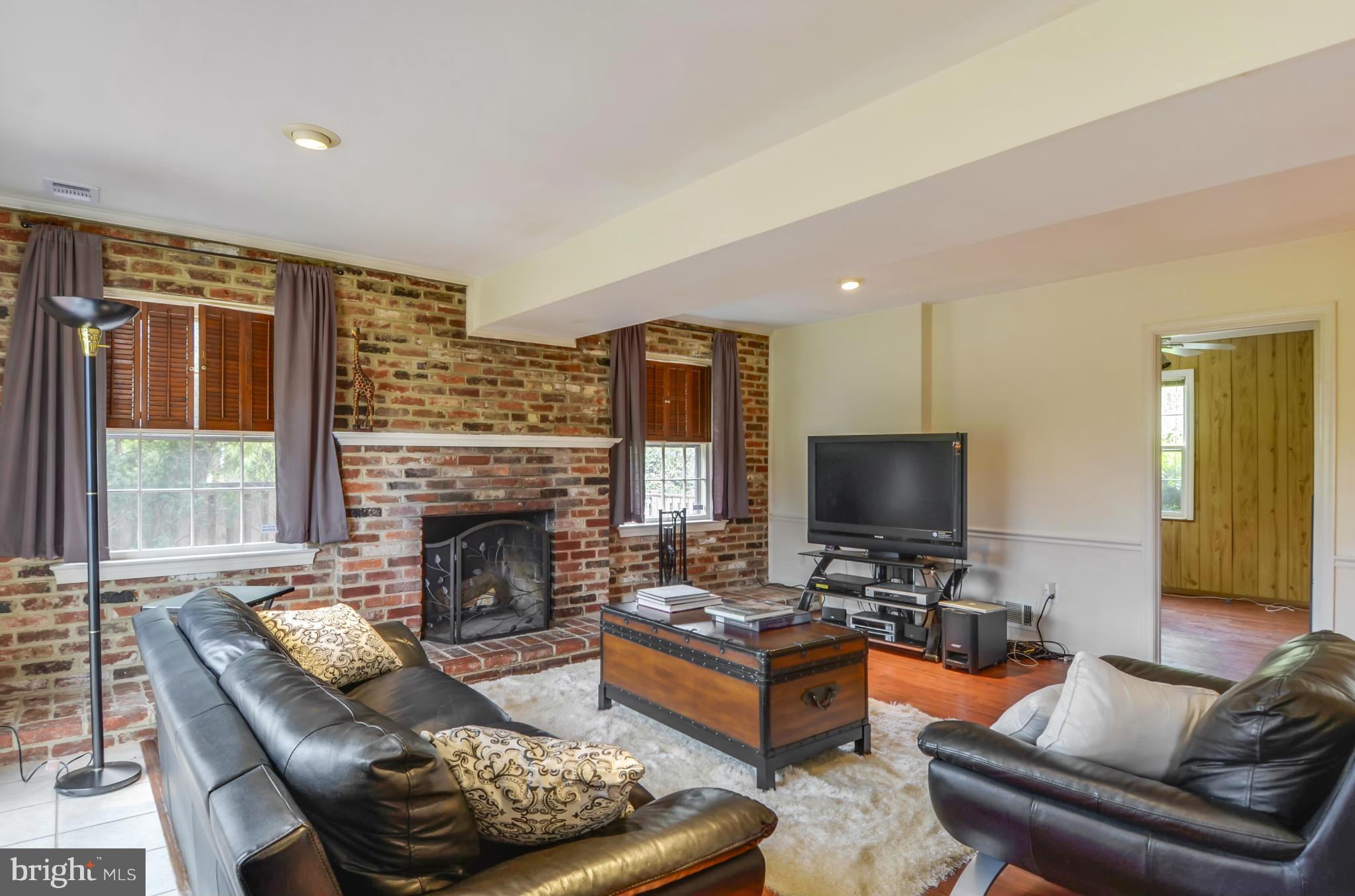 1395 Kimblewick Road Potomac, MD 20854 - Photo 12 of 30 a living room with furniture and a fireplace