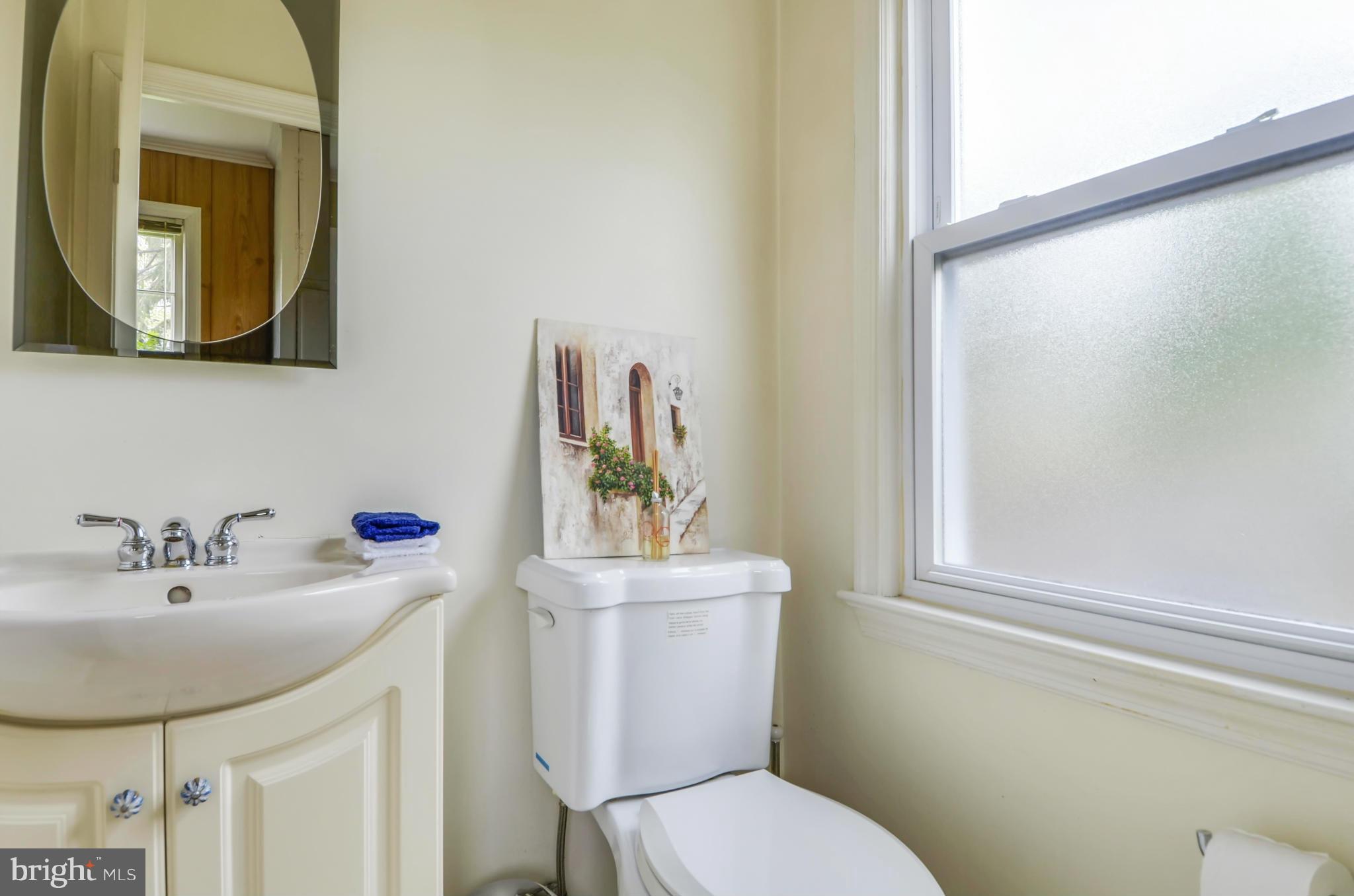 1395 Kimblewick Road Potomac, MD 20854 - Photo 15 of 30 a bathroom with a sink mirror and toilet