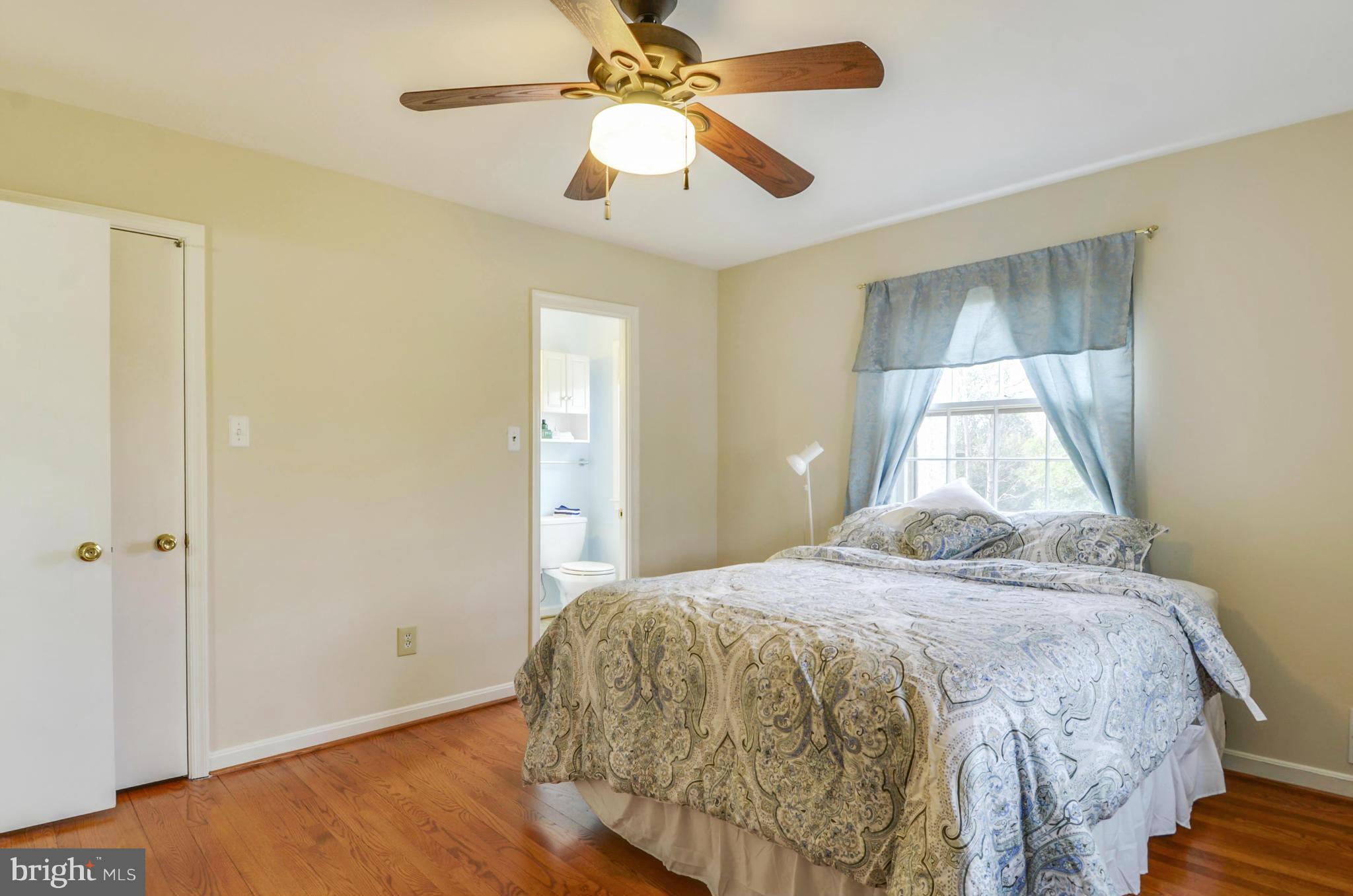 1395 Kimblewick Road Potomac, MD 20854 - Photo 17 of 30 a bedroom with a bed and a chandelier