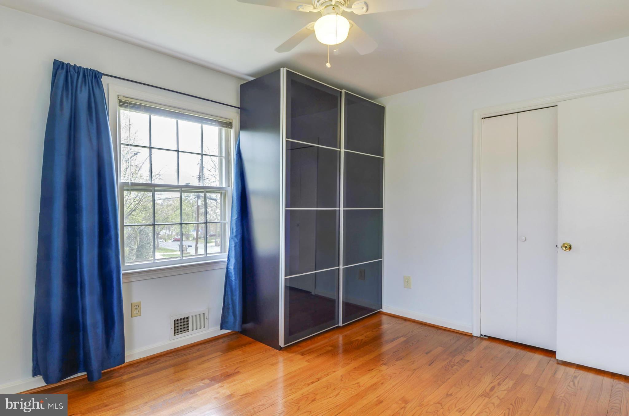 1395 Kimblewick Road Potomac, MD 20854 - Photo 20 of 30 a view of an empty room with wooden floor and a window