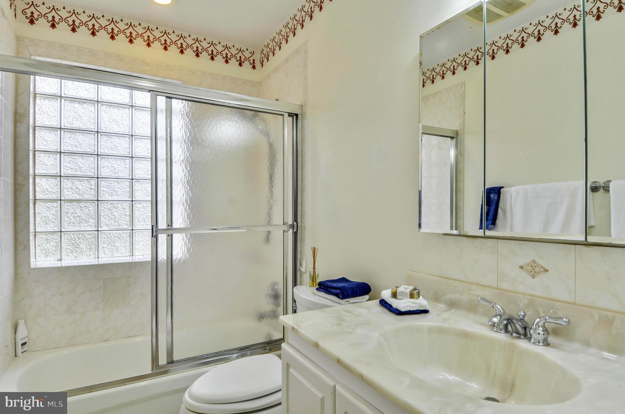 1395 Kimblewick Road Potomac, MD 20854 - Photo 22 of 30 a bathroom with a sink toilet and shower