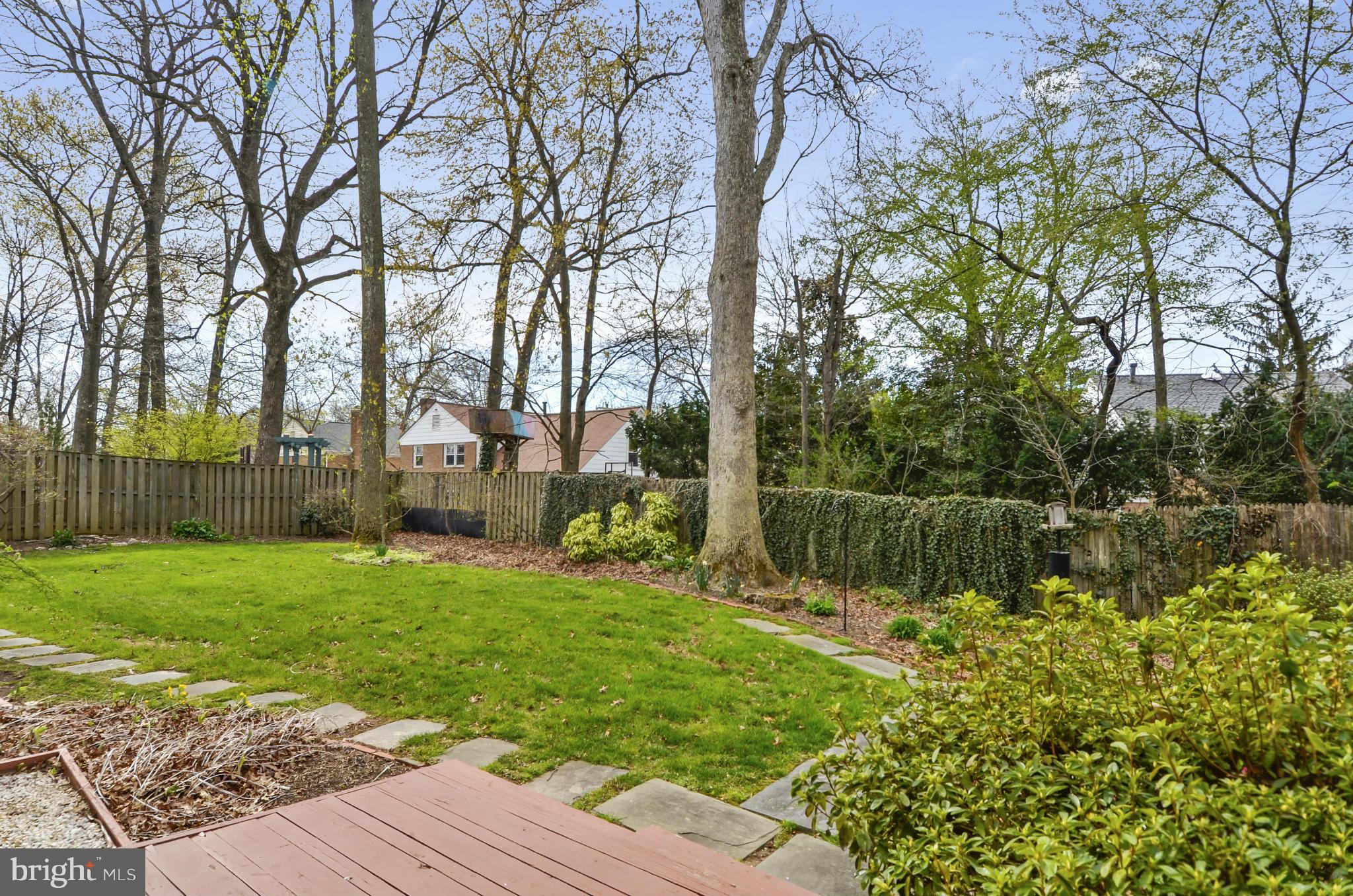 1395 Kimblewick Road Potomac, MD 20854 - Photo 27 of 30 a backyard of a house with lots of green space and fountain