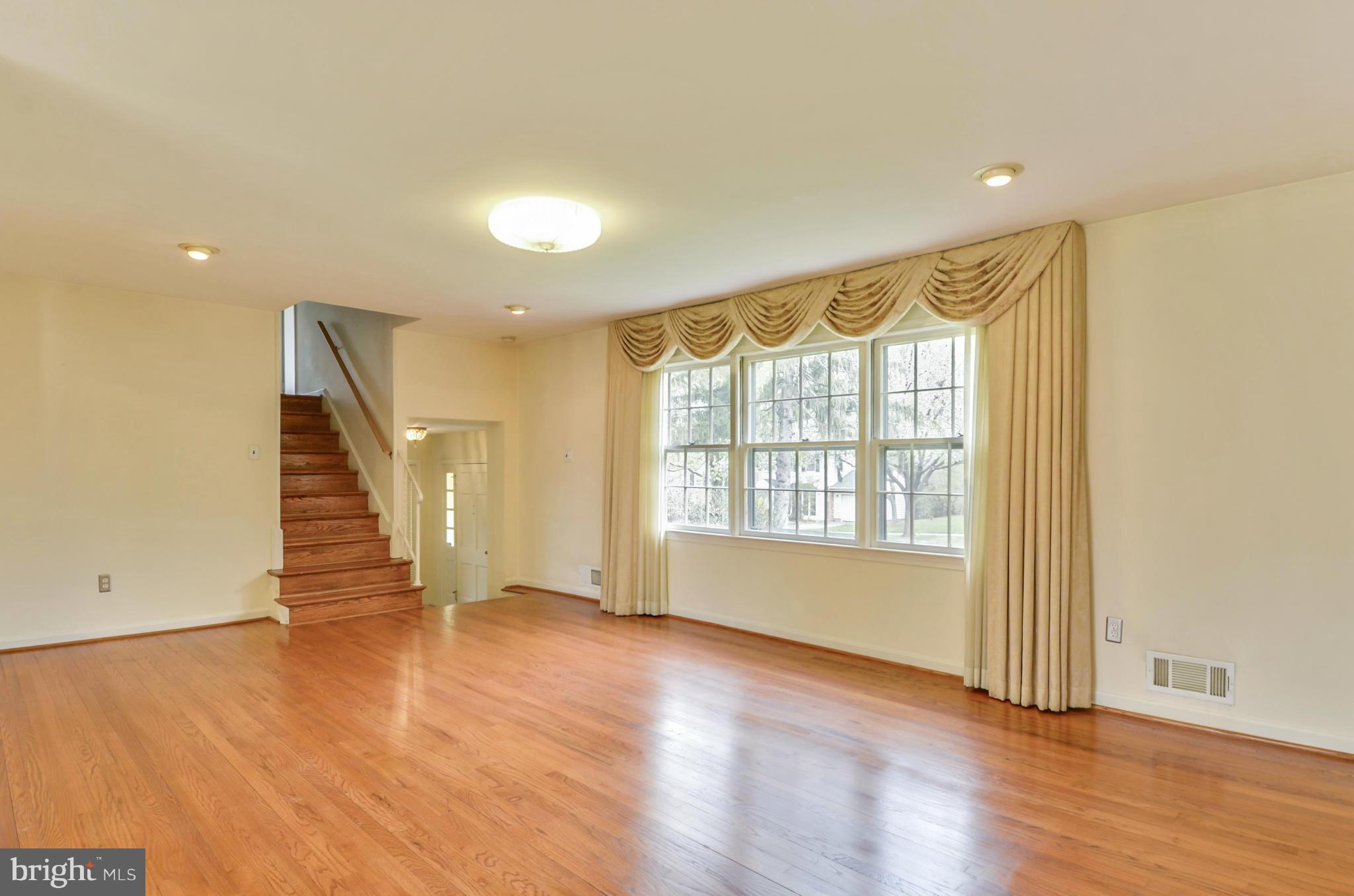 1395 Kimblewick Road Potomac, MD 20854 - Photo 4 of 30 a view of an empty room with wooden floor and a window