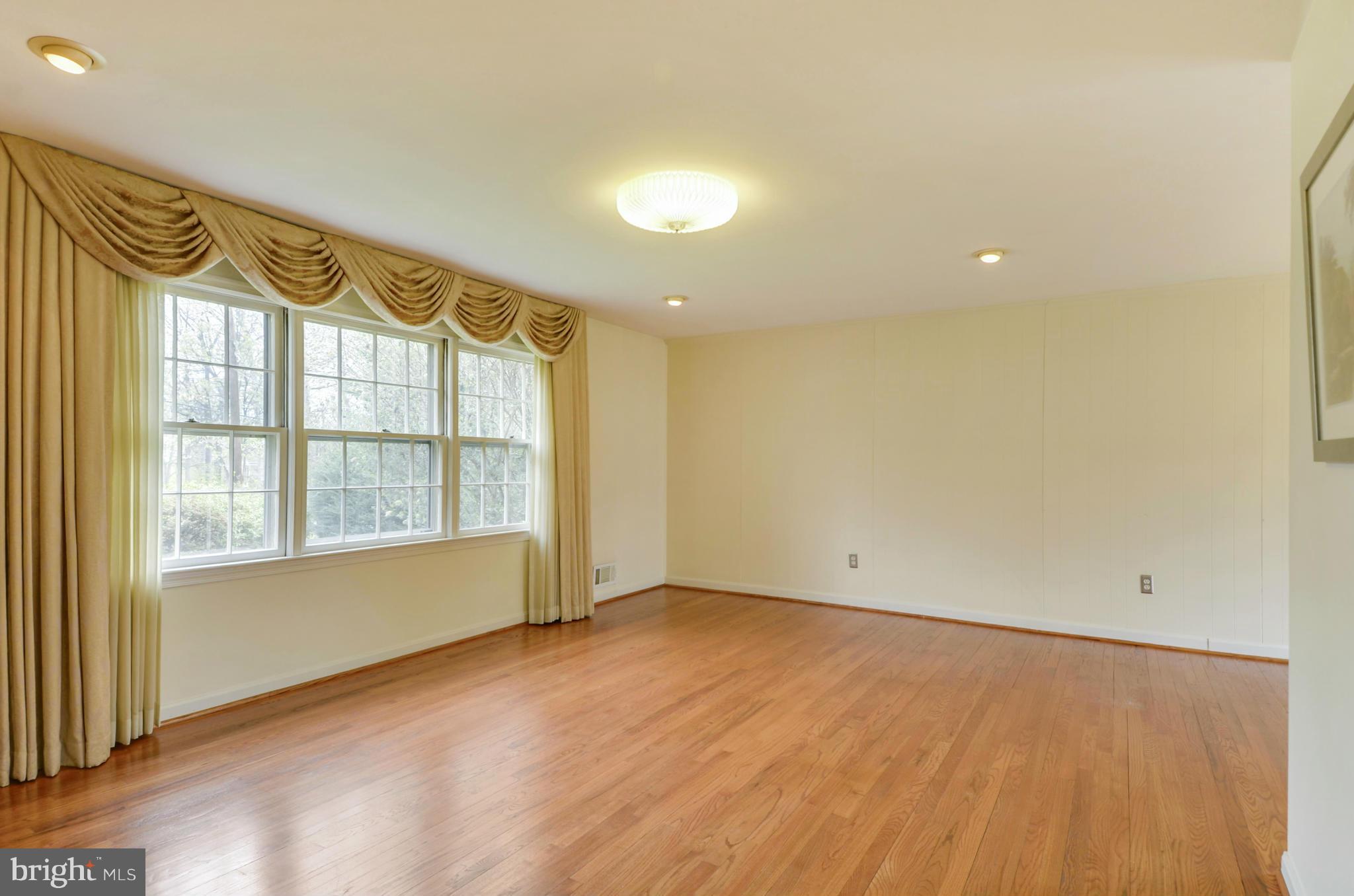 1395 Kimblewick Road Potomac, MD 20854 - Photo 5 of 30 an empty room with wooden floor and windows