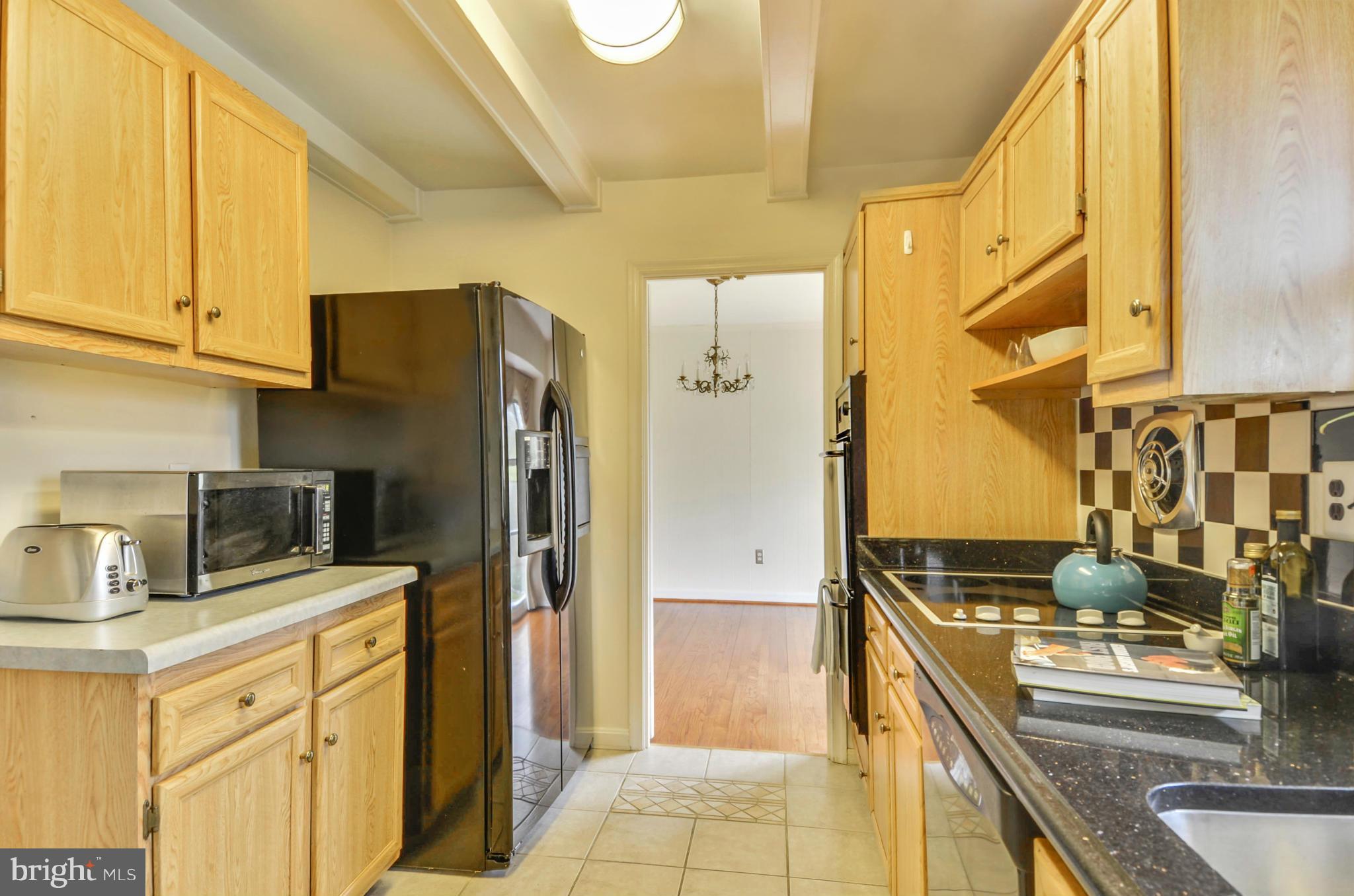 1395 Kimblewick Road Potomac, MD 20854 - Photo 7 of 30 a kitchen with stainless steel appliances granite countertop a refrigerator and a stove