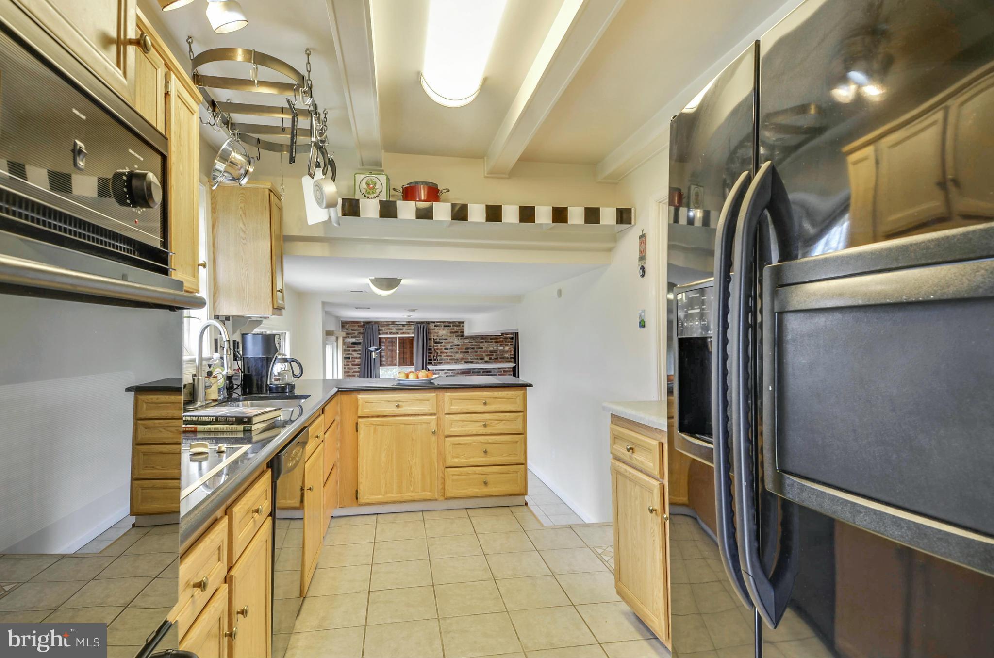 1395 Kimblewick Road Potomac, MD 20854 - Photo 8 of 30 a kitchen with stainless steel appliances granite countertop a sink and dishwasher a refrigerator a oven with the cabinets