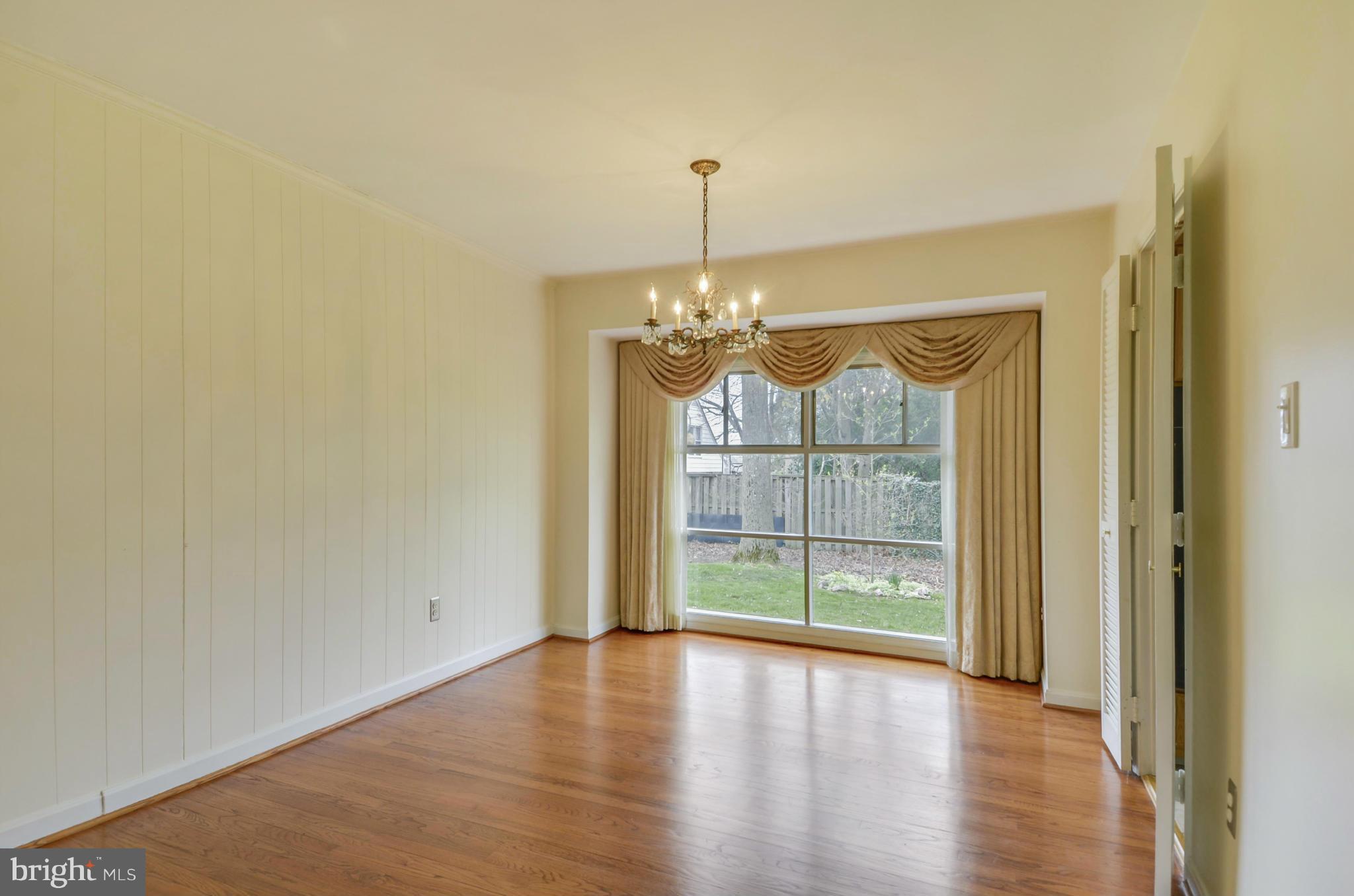 1395 Kimblewick Road Potomac, MD 20854 - Photo 9 of 30 a view of an empty room with wooden floor and a window