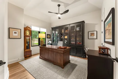 a living room with furniture and large windows