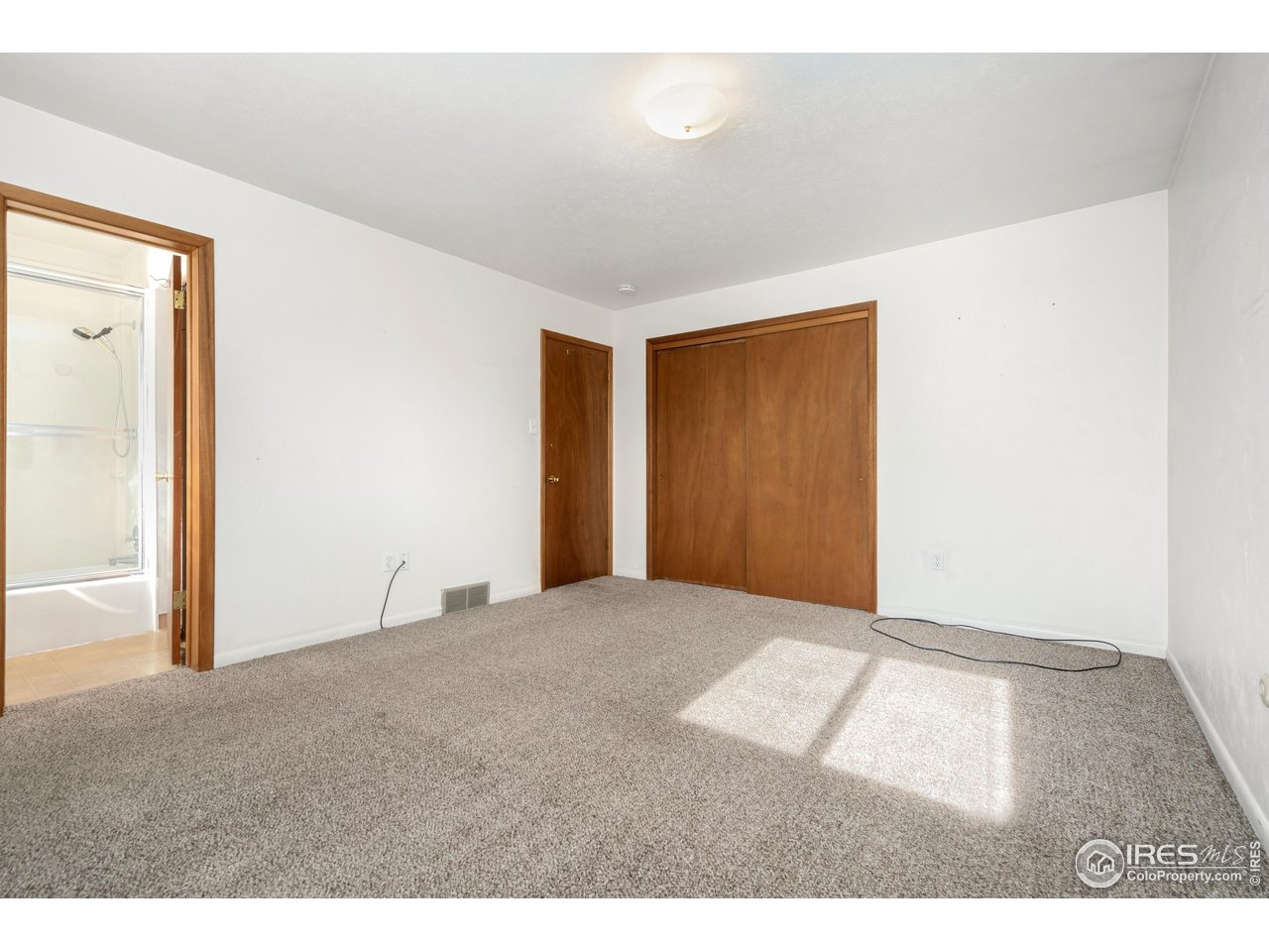 409 7th Street Windsor, CO 80550 - Photo 23 of 42 a view of an empty room with wooden floor