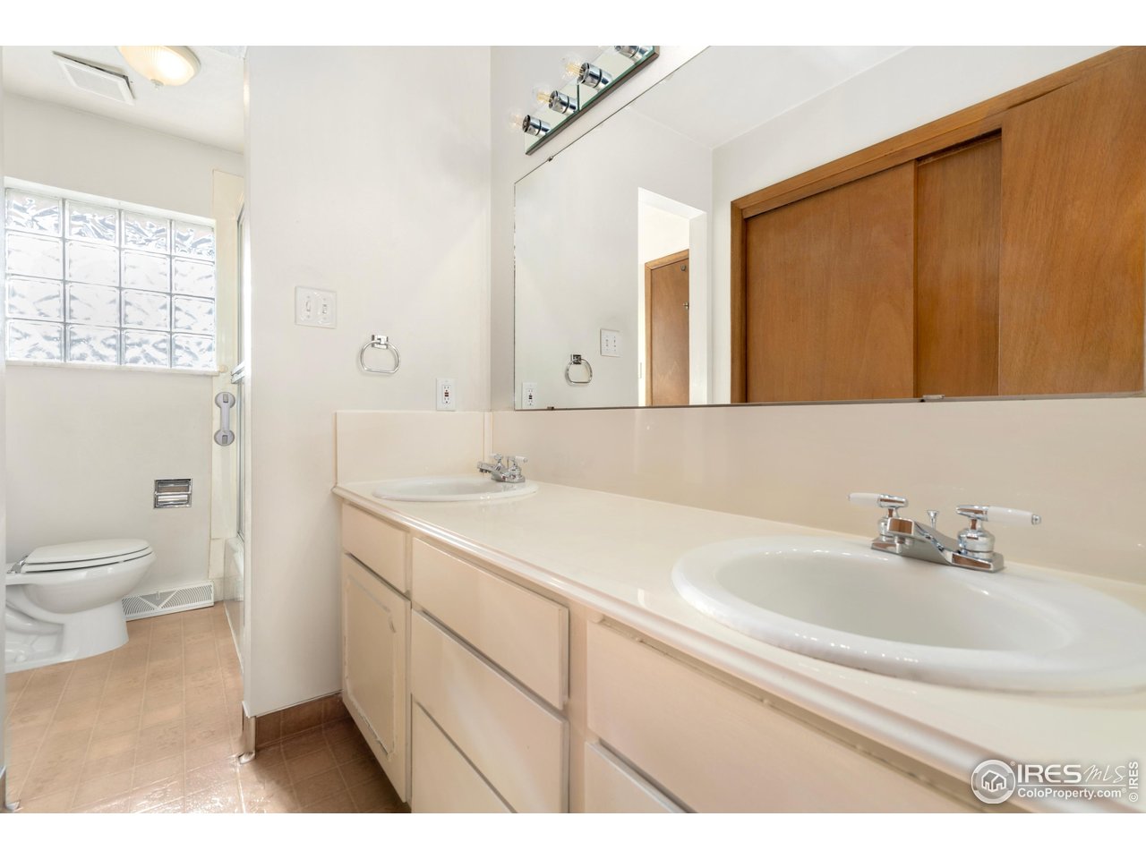 409 7th Street Windsor, CO 80550 - Photo 25 of 42 a bathroom with a sink a toilet and a mirror