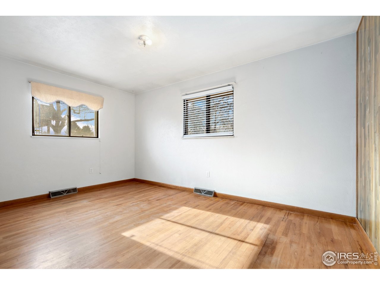 409 7th Street Windsor, CO 80550 - Photo 26 of 42 a view of an empty room with wooden floor