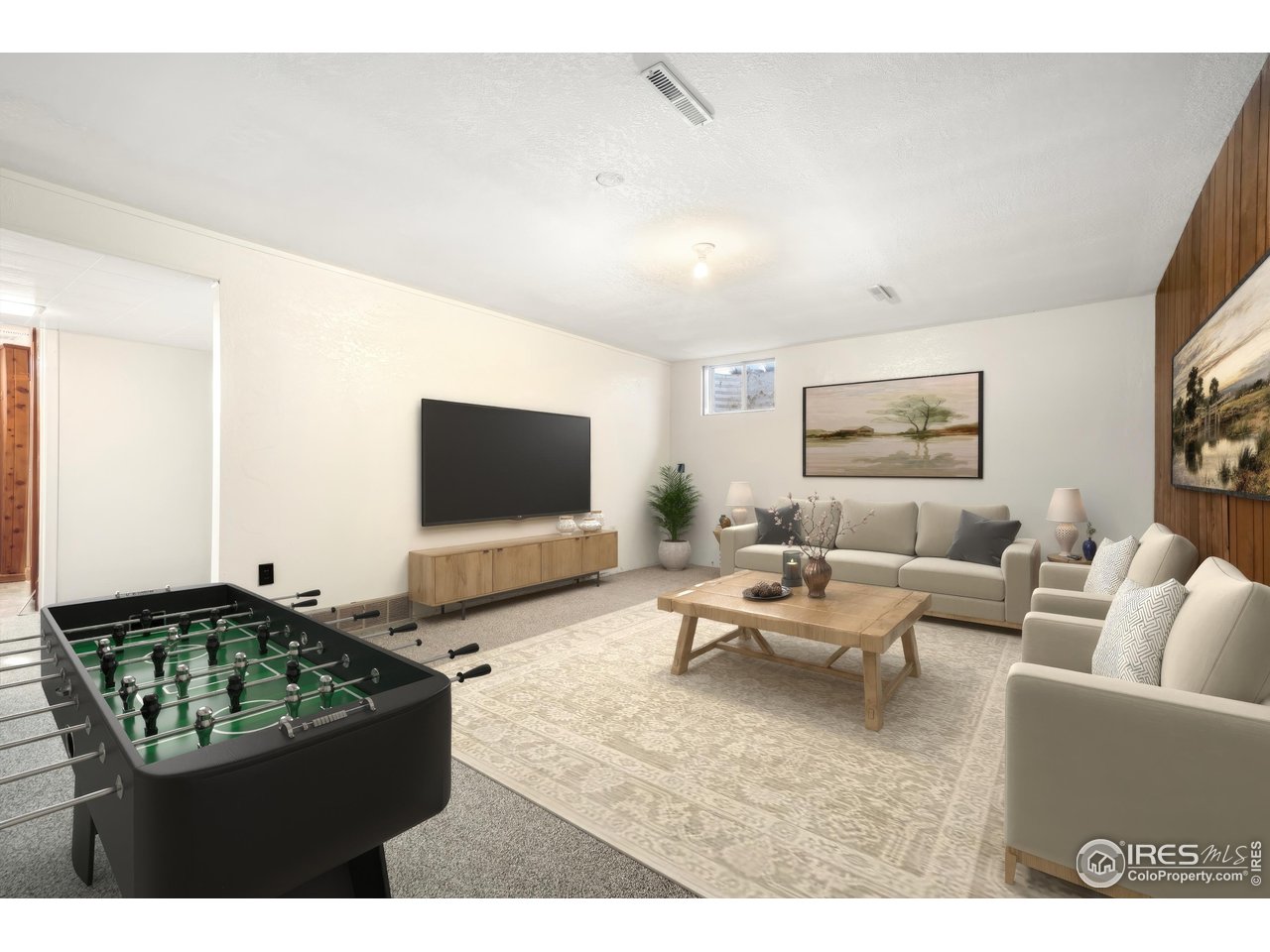 409 7th Street Windsor, CO 80550 - Photo 29 of 42 a living room with furniture and a flat screen tv