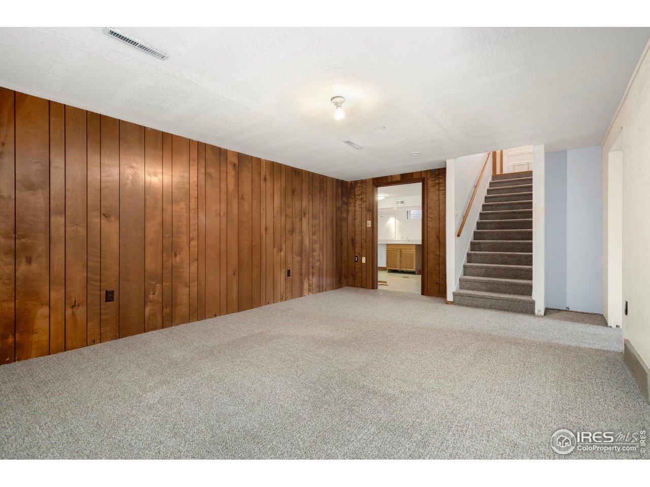 409 7th Street Windsor, CO 80550 - Photo 32 of 42 a view of an empty room with wooden floor