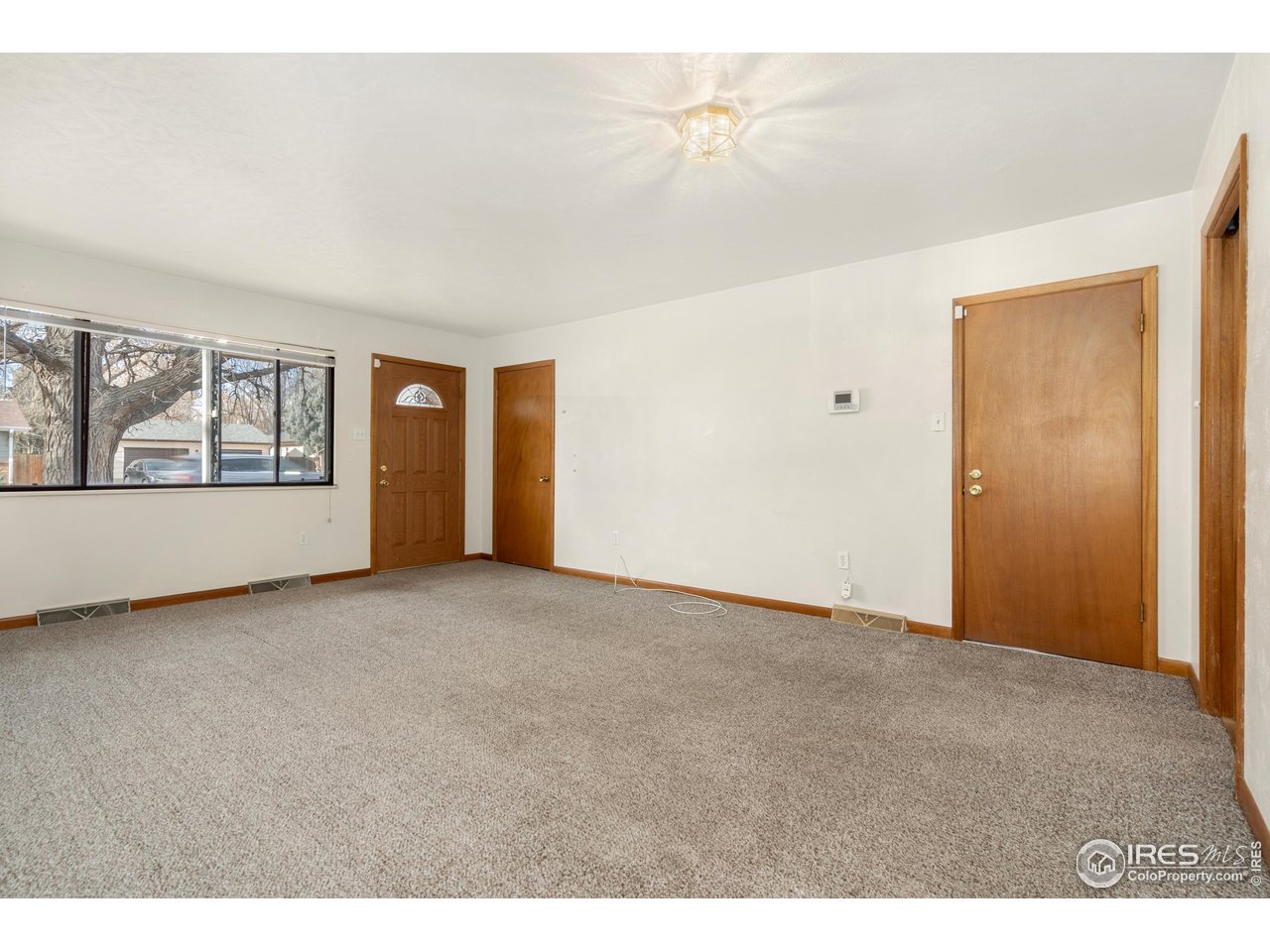 409 7th Street Windsor, CO 80550 - Photo 7 of 42 a view of an empty room with a window