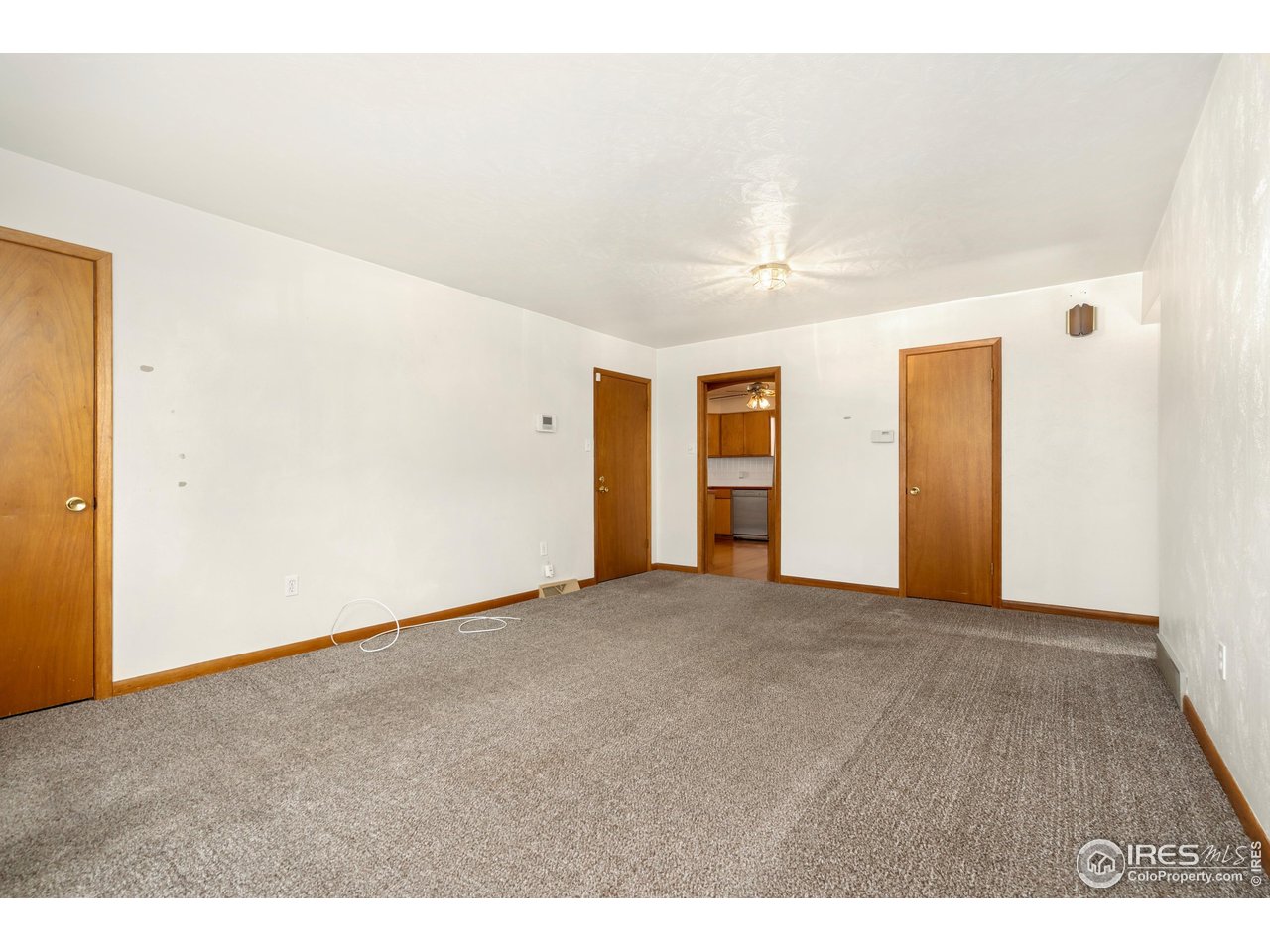 409 7th Street Windsor, CO 80550 - Photo 8 of 42 a view of an empty room with wooden floor