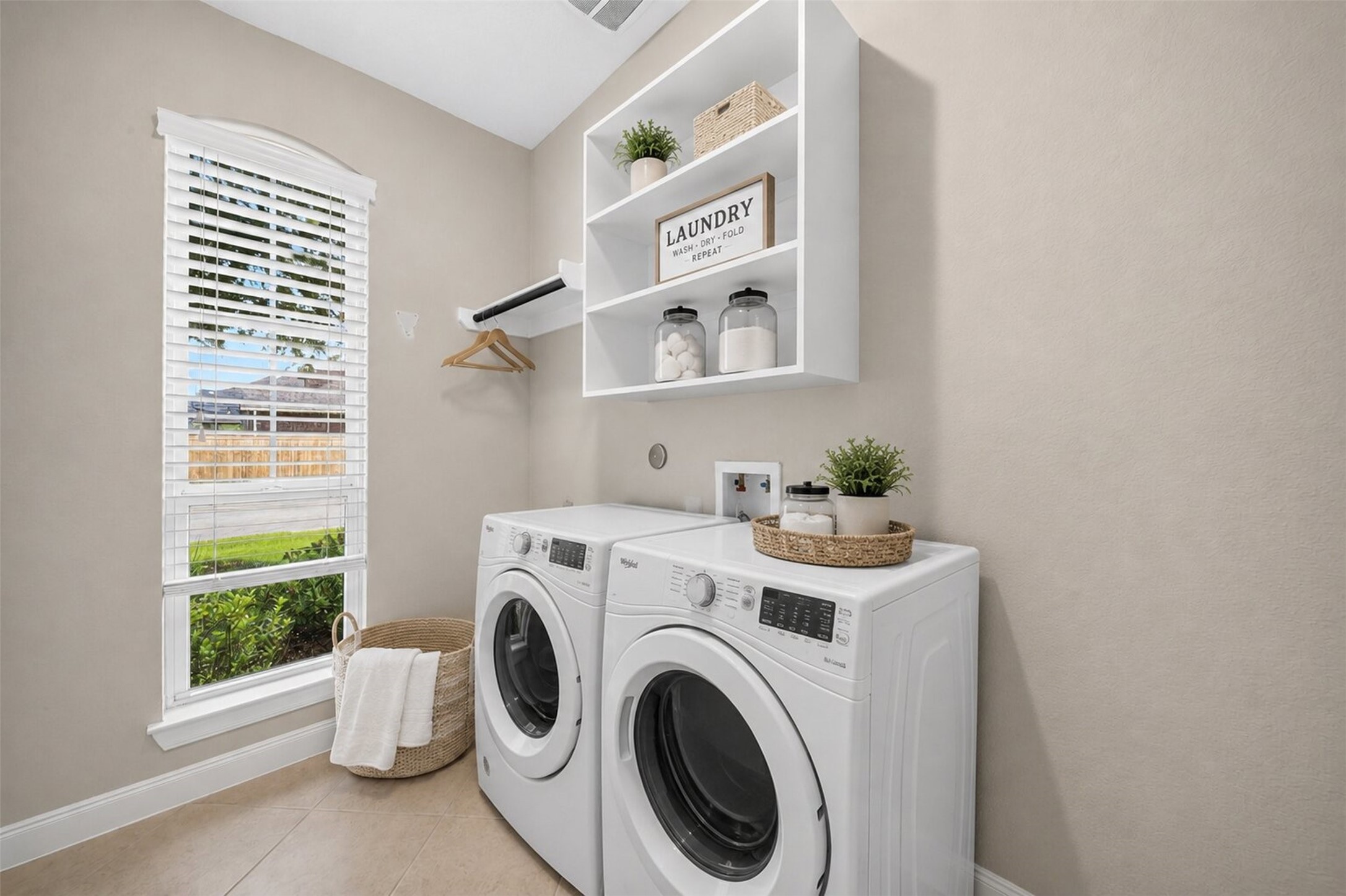6234 Avon Landing Lane Spring, TX 77379 - Photo 19 of 49 The laundry room has a nice large window that allow plenty of light, hanging space for air drying and a shelf for convenience. Virtually staged for ideas.