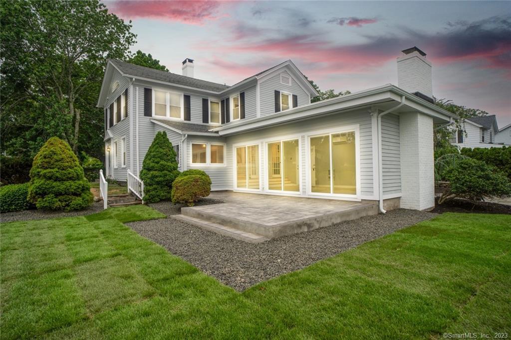 121 Middle Beach Road Madison, CT 06443 - Photo 1 of 1 a view of a house with a small yard and a large tree
