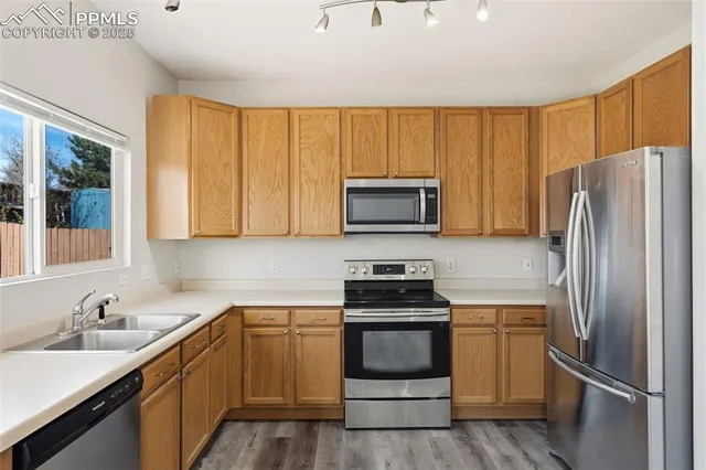 a kitchen with a refrigerator sink and microwave