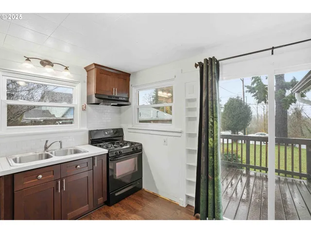 a kitchen with kitchen island a counter top space cabinets and stainless steel appliances