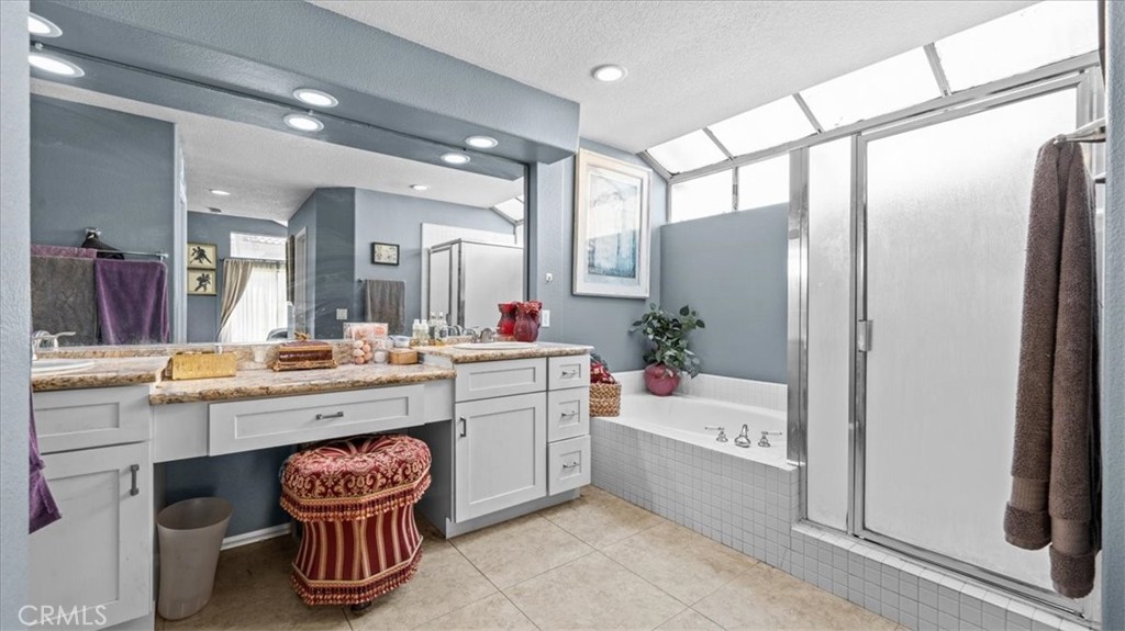 1671 Dominguez Ranch Road Corona, CA 92878 - Photo 20 of 42 a bathroom with a granite countertop sink and a mirror