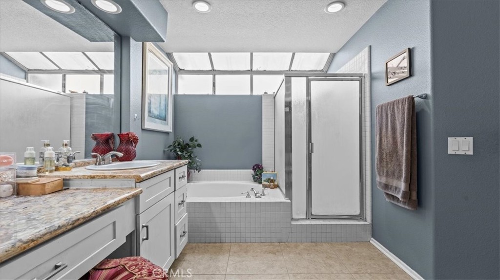 1671 Dominguez Ranch Road Corona, CA 92878 - Photo 22 of 42 a bathroom with a granite countertop sink and a mirror