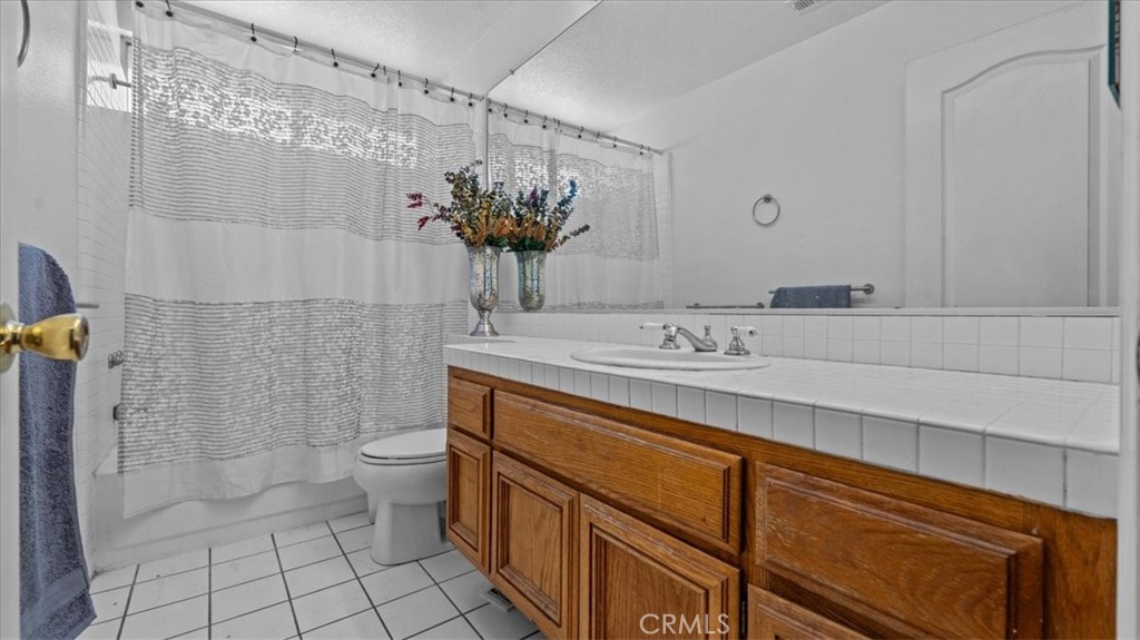 1671 Dominguez Ranch Road Corona, CA 92878 - Photo 24 of 42 a bathroom with a sink a toilet and shower