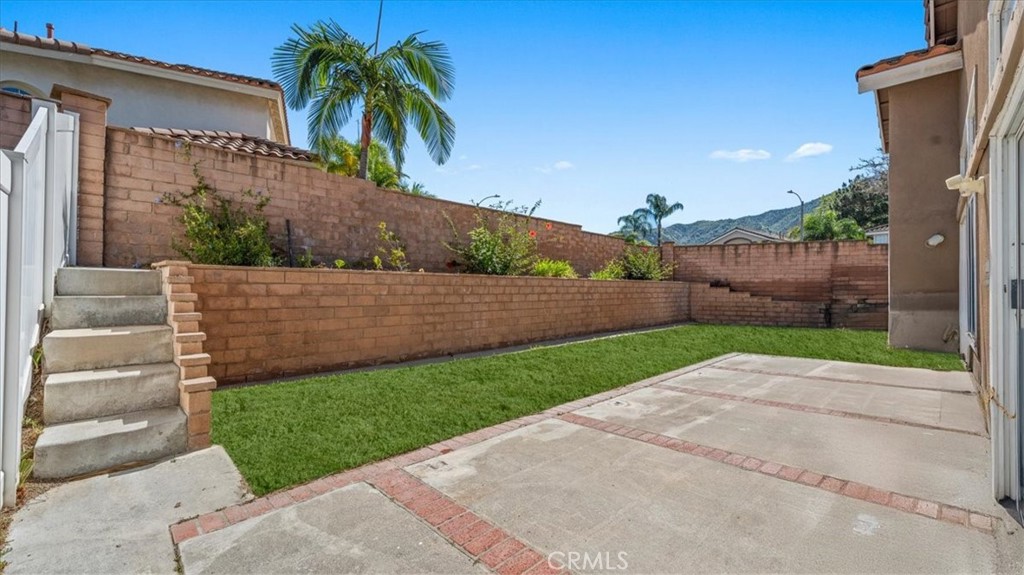 1671 Dominguez Ranch Road Corona, CA 92878 - Photo 28 of 42 a view of a back yard with a house