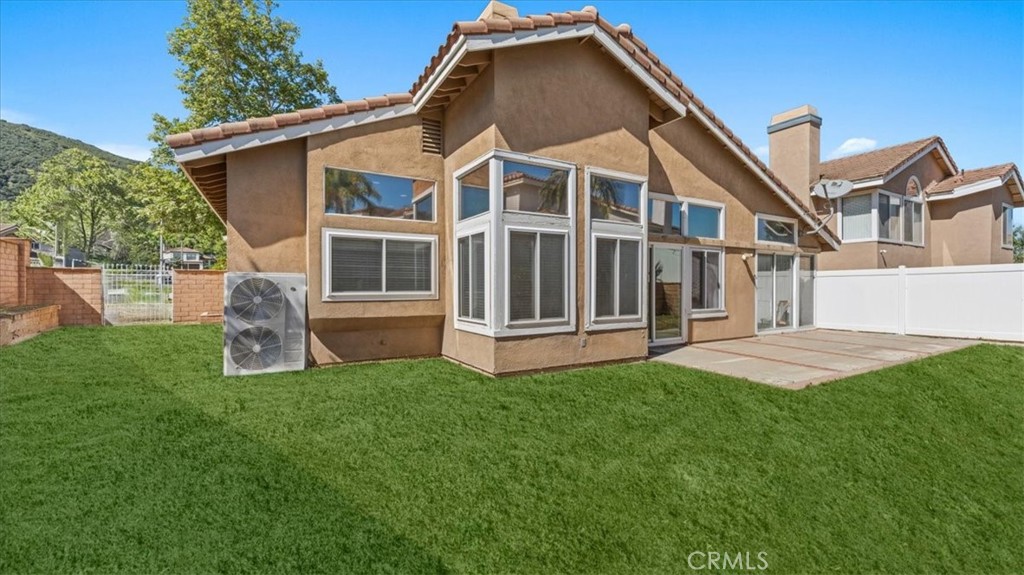 1671 Dominguez Ranch Road Corona, CA 92878 - Photo 30 of 42 a front view of a house with a yard