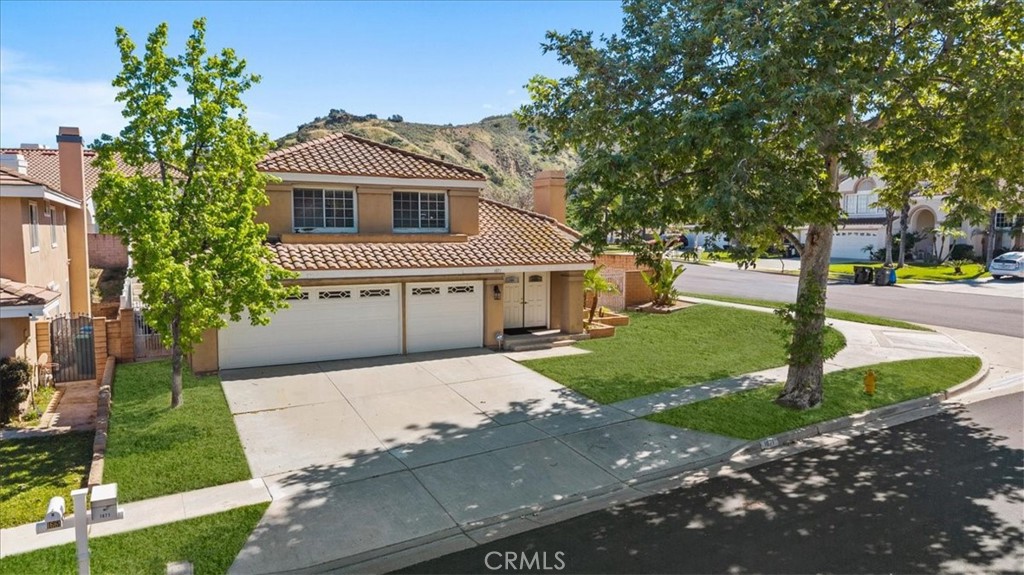 1671 Dominguez Ranch Road Corona, CA 92878 - Photo 33 of 42 a front view of a house with a yard and garage