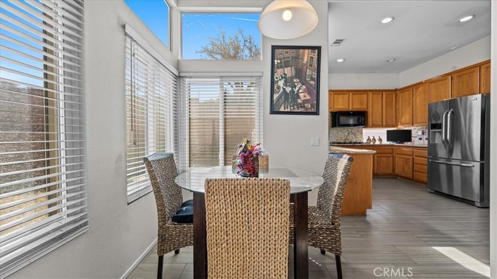 1671 Dominguez Ranch Road Corona, CA 92878 - Photo 10 of 42 a kitchen with stainless steel appliances wooden floor and wooden cabinets