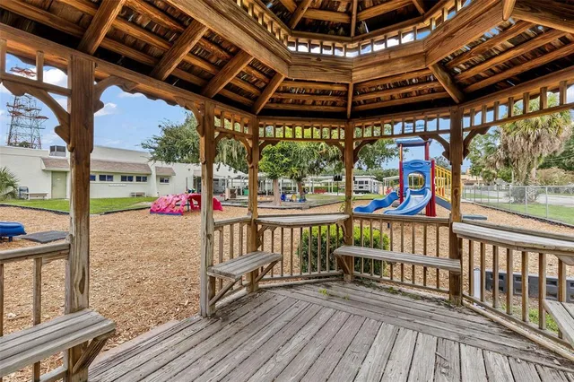 a living room with furniture a flat screen tv and a table