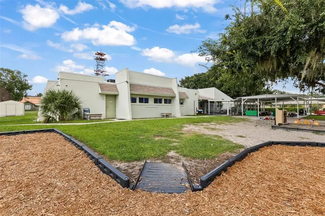 a view of a dining room with furniture and a kitchen
