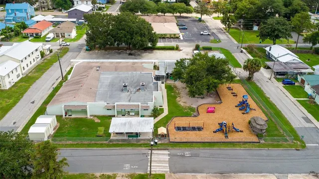 an aerial view of residential houses with outdoor space and swimming pool