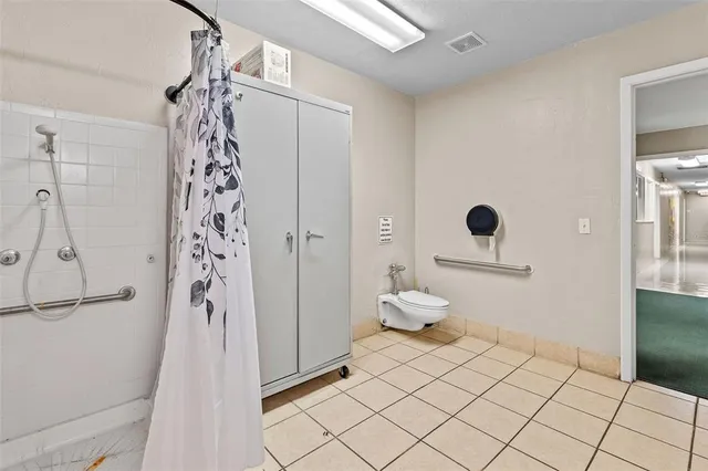 a bathroom with a toilet a sink and a mirror