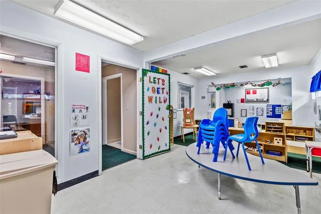 a view of a play room with furniture and toys