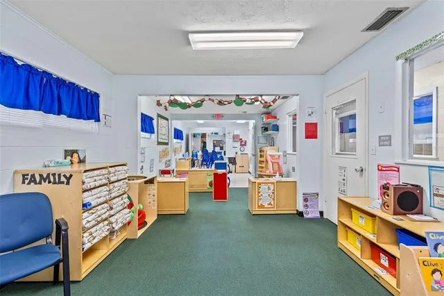 a view of a play room with furniture and a table